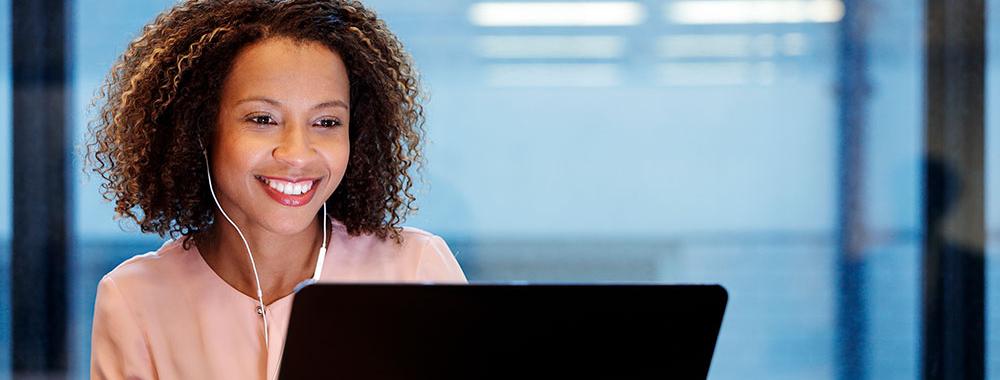 smiling woman using laptop computer