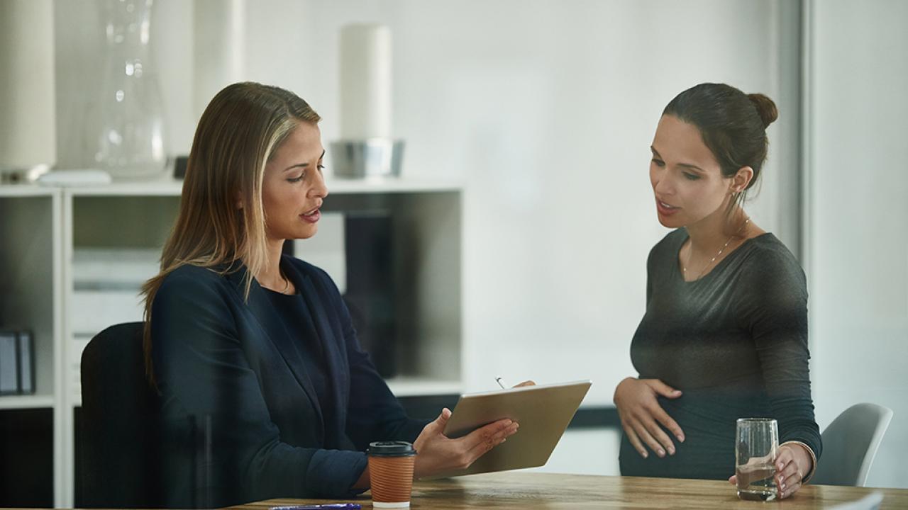 HR professional talking to pregnant employee