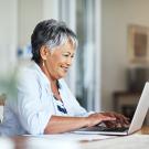 smiling senior woman on a laptop at home